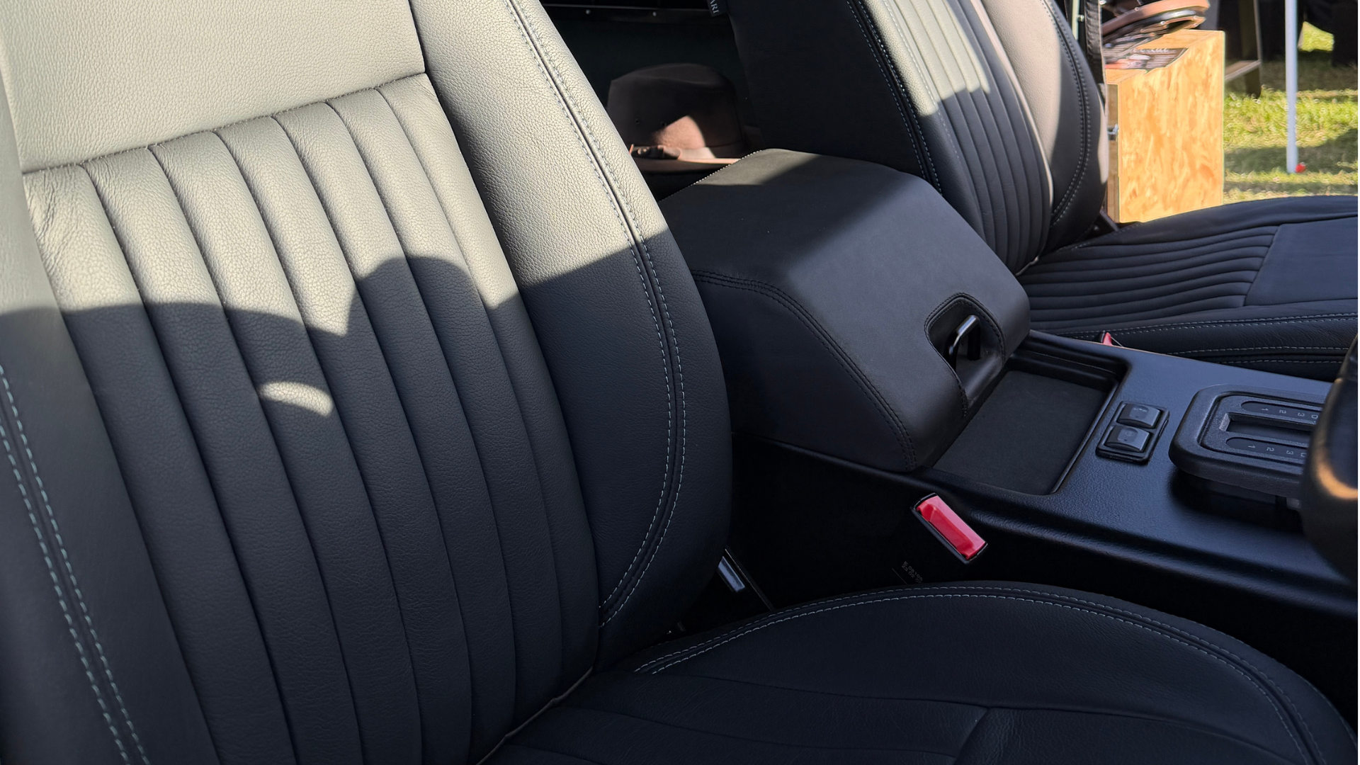 Black leather with green stitch seats in a Defender.