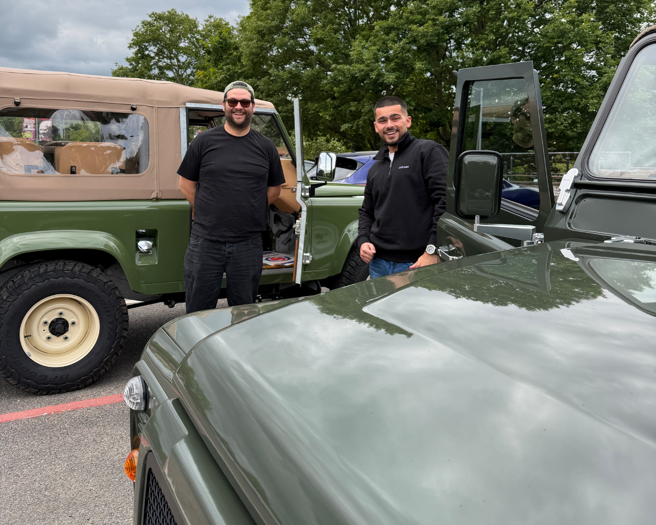 LUCARI's Sales Manager Tom and Partnerships Manager Leo outside LUCARI-build Land Rover Defender 90 and Defender 110