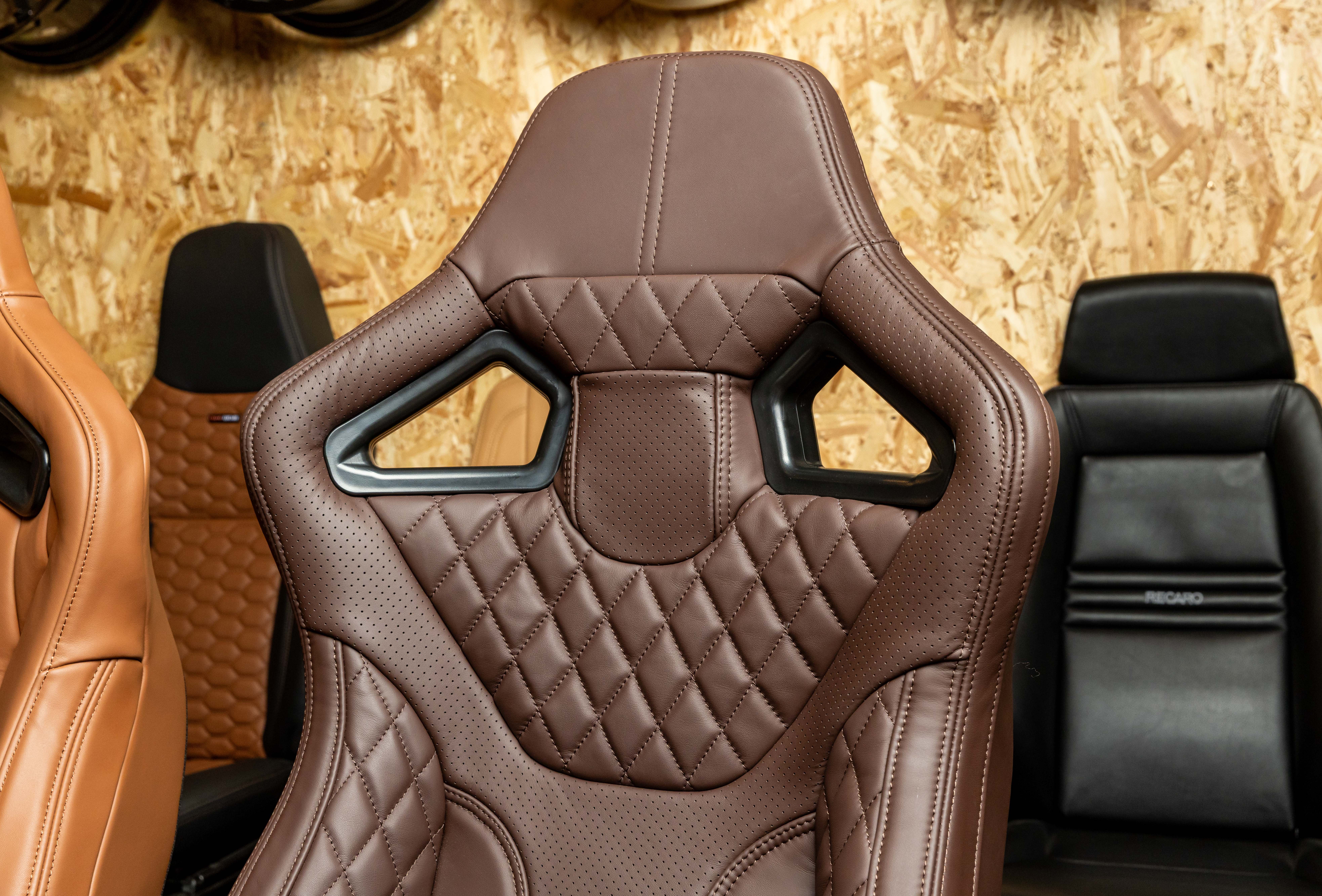 Close-up of a LUCARI RXI Front Seat trimmed in Chocolate Leather showing the Hex stitching pattern